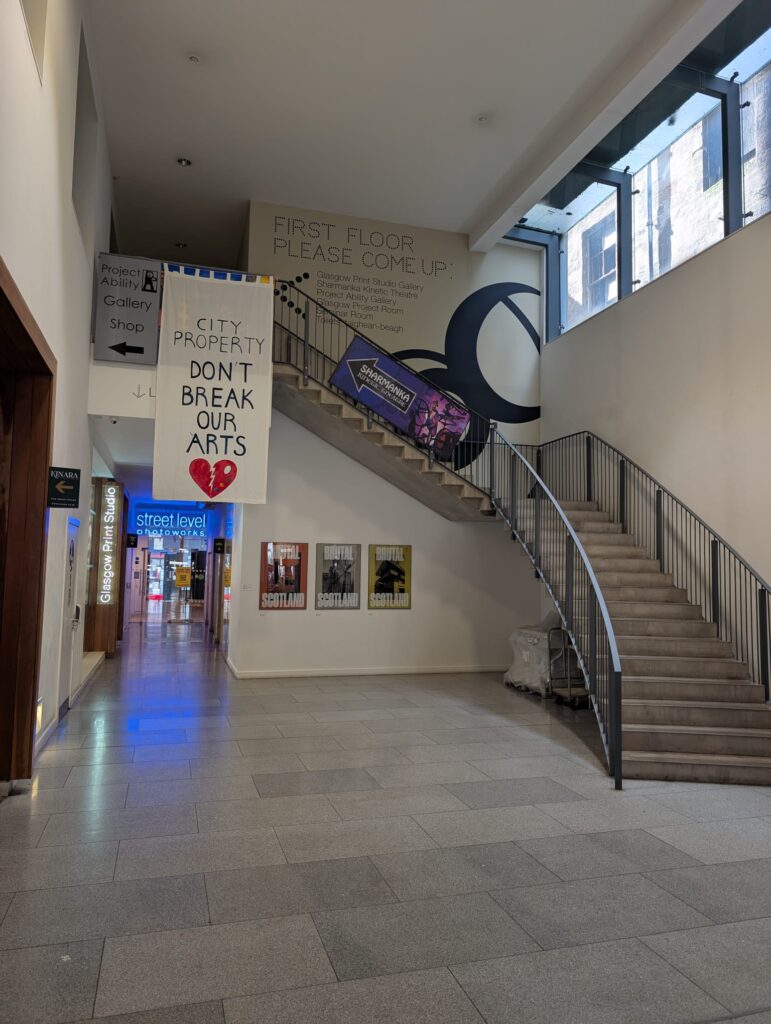A view of a reception, with stairs curving around from right to left