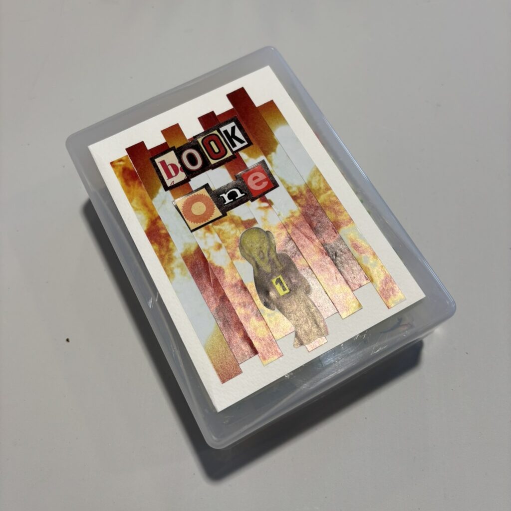 A plastic box with a collaged lid. The image is a nuclear blast cloud, but cut into strips and rearranged. "Book One (1)" is spelled out in letters cut from newspapers and magazines. The screamer from Edvard Munch's "The Scream" is pasted below the title.
