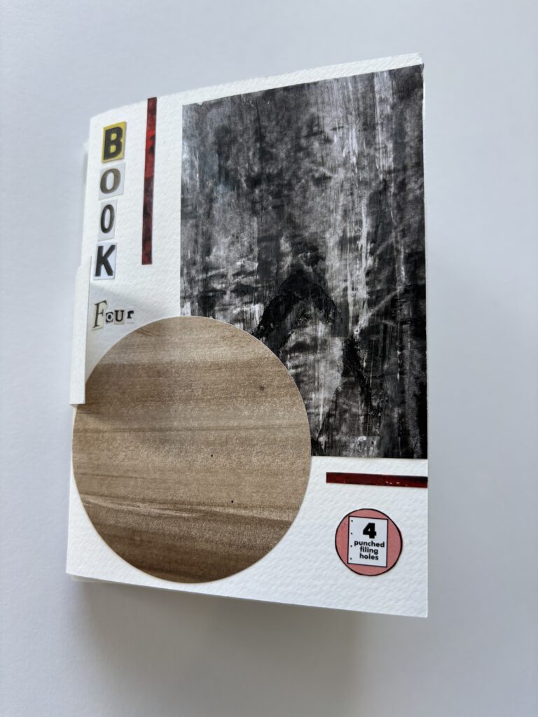 A hand-bound book. The cover is collaged. There is a large circle of brown, earthy card, overlapping with a rectangle of textured black. The title reads "Book Four (4)"